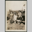 Family pose along side car (ddr-densho-359-713)