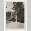 Woman shrugging by a car (ddr-densho-404-416)