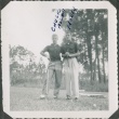 Two men stand with golf clubs (ddr-densho-321-387)