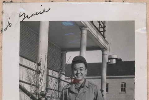 Signed photograph of a man in front of a building (ddr-manz-10-113)