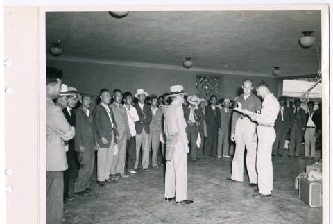 Sgt. Markiewicz, Pfc. Supulsky, and group of incarcerated Japanese Americans (ddr-densho-1007-22)
