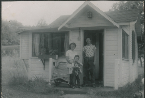 Agnes Sakura with two boys in door of cabin (ddr-densho-523-242)