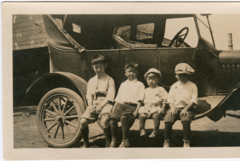 Four boys sitting on car (ddr-densho-458-26)