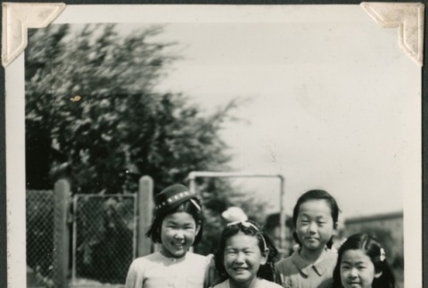 Four girls in a schoolyard (ddr-densho-321-171)