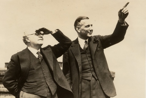Two men looking at something outside (ddr-njpa-1-2560)