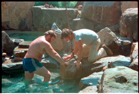 Placing rock into pool (ddr-densho-377-2495)