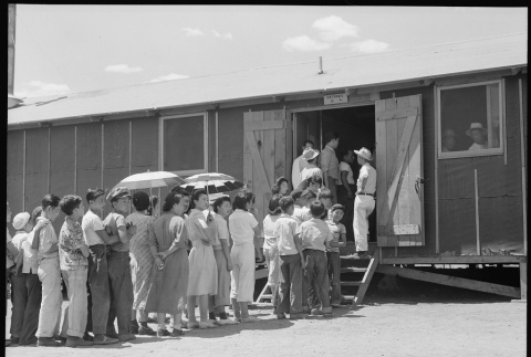 Japanese Americans waiting in mess hall line (ddr-densho-151-369)