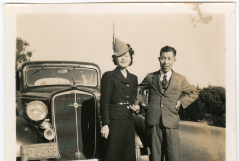 Tomoye (Nozawa) Takahashi and unknown man standing by car (ddr-densho-426-1658)