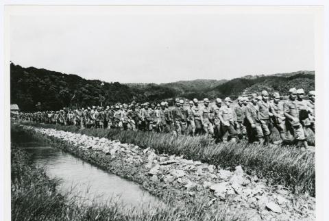 Japanese servicepeople escorted by American Marines after Japanese surrender (ddr-densho-1007-259)
