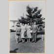 Three women and a man outside house (ddr-densho-522-59)