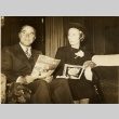 A couple reading Nippon Golfdom (ddr-njpa-1-1928)