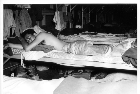 Nisei soldier relaxing in barracks (ddr-densho-114-61)