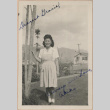 Signed photograph of a woman standing next to a tree (ddr-manz-10-21)