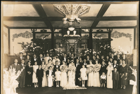 Wedding party stands in front of a shrine (ddr-densho-395-5)