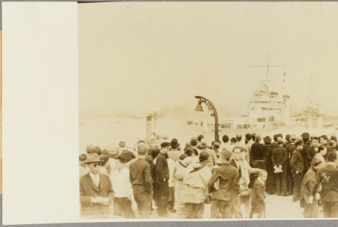 Japanese civilians gathered on a dock to watch the USS Astoria (ddr-njpa-13-359)