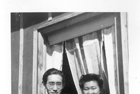 Nisei man and woman in barracks window (ddr-densho-157-36)