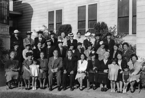 Group photo of men, women and children outside building (ddr-ajah-4-10)