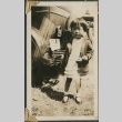 Young girl standing next to a car (ddr-densho-321-733)