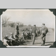 Group of men sitting alongside road (ddr-ajah-2-444)