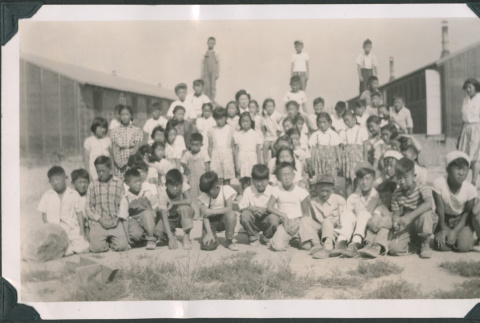 Crowd of children near barracks (ddr-densho-483-1097)