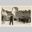 Two men hold flags at the front of a procession (ddr-sbbt-4-10)