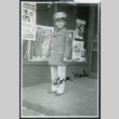 Photograph of Ned Morioka posing in front of a store front (ddr-csujad-47-139)