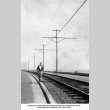 Man walking on railroad tracks (ddr-ajah-6-422)