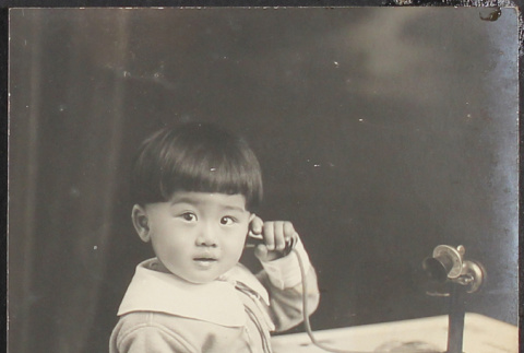 A young boy on the phone (ddr-densho-278-207)