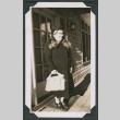 Photo of a woman in an overcoat with a handbag (ddr-densho-483-393)