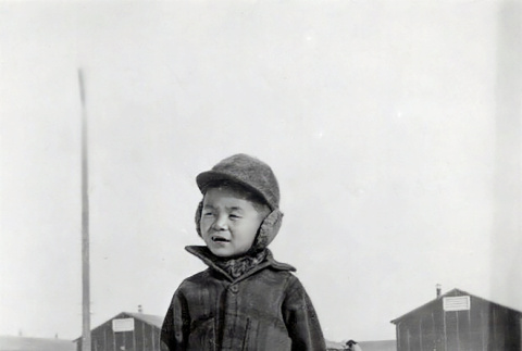 Lester Ichiro Hashiguchi standing in snow at Minidoka (ddr-densho-474-203)