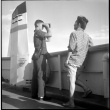 Sally (Fujii) Domoto and boy, likely Anyo Domoto, standing by ferry rail (ddr-densho-329-712)