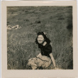 Tomoye (Nozawa) Takahashi sitting in a field (ddr-densho-426-1942)