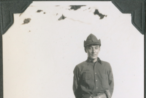 Man standing by snow bank (ddr-ajah-2-319)