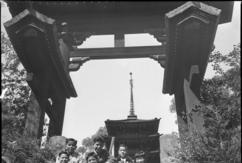 Group sitting on stairs leading to tea garden in Golden Gate Park (ddr-densho-426-956)