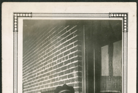Young boy by brick wall (ddr-densho-293-110)