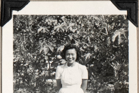 Woman standing by small trees (ddr-densho-587-21)