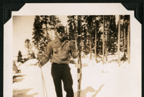 Walter Matsuoka stands with skis (ddr-densho-390-100)