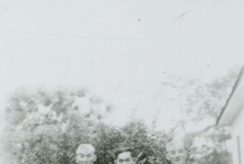 Three men in front of a bush (ddr-densho-1007-497)