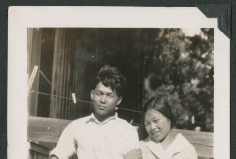 boy and girl leaning against a fence (ddr-densho-378-537)