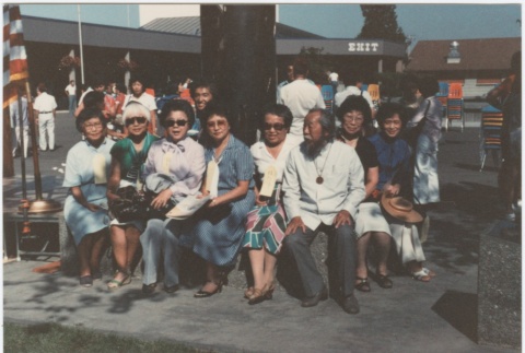 Sitting in front of the Puyallup Assembly Center memorial (ddr-densho-10-166)