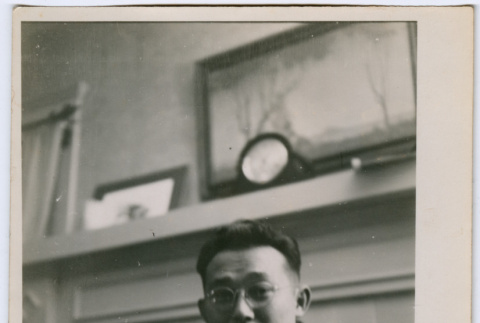 Man in front of fireplace mantle (ddr-densho-329-815)