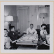 Group playing Monopoly (ddr-densho-522-554)