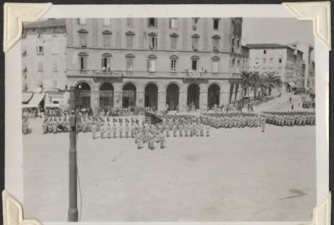 Rows of men in parade with color guard, seen from above (ddr-densho-466-759)