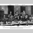 Group of men at table with food and drinks (ddr-ajah-3-13)