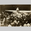 Wiley Post climbing out of his plane in front of a crowd (ddr-njpa-1-1321)