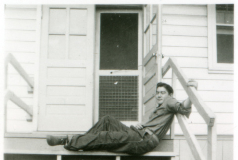 Man posing on stoop (ddr-densho-1007-604)