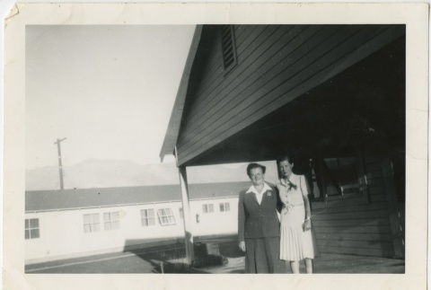 Two women standing in front of a building (ddr-manz-7-110)