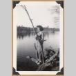 Woman posing on a fallen tree (ddr-densho-542-329)