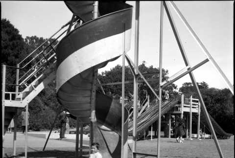 Boy on corkscrew slide in park (ddr-densho-426-961)