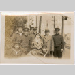 Tomoyuki Nozawa and girl (possibly Martha) standing with group of men in Japanese naval uniforms (ddr-densho-426-2029)
